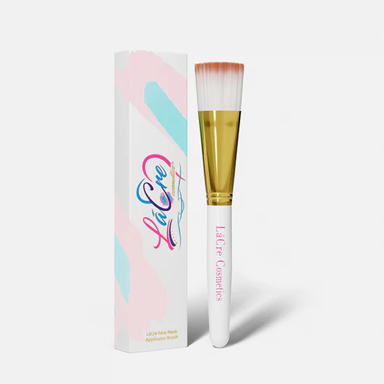 A makeup brush with white and pink bristles and a decorative box.