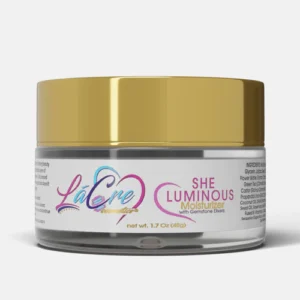 A jar of She Luminous face cream with a gold lid.